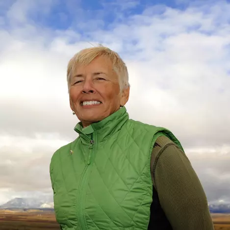 Barbara Vasquez smiling against a cloudy background.