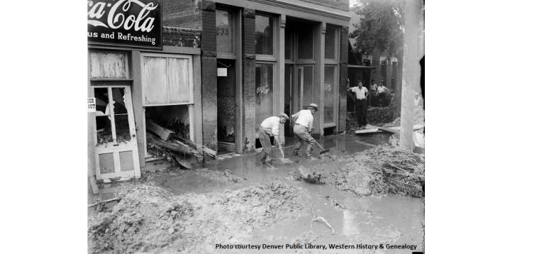 Two men shoveling water and debris away from store fronts in Denver after the 1880 Cherry Creek flood 1880