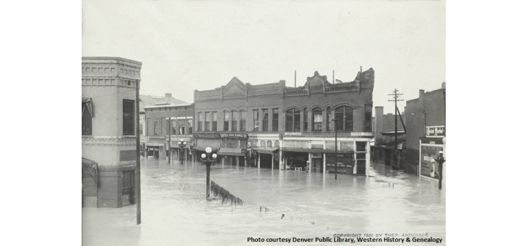 Storefronts partially submerged in Pueblo 1921