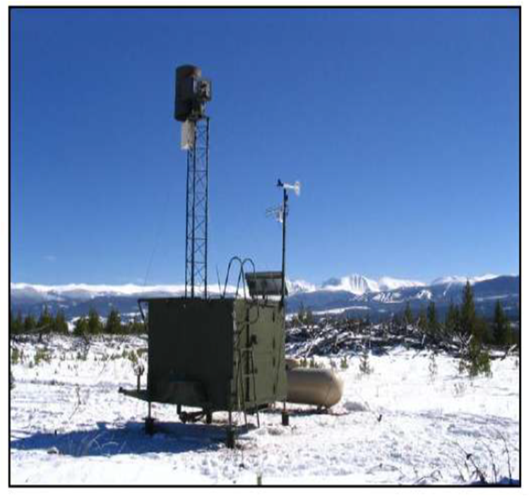 A square ground based cloud seeding generator sits in a snow-covered field